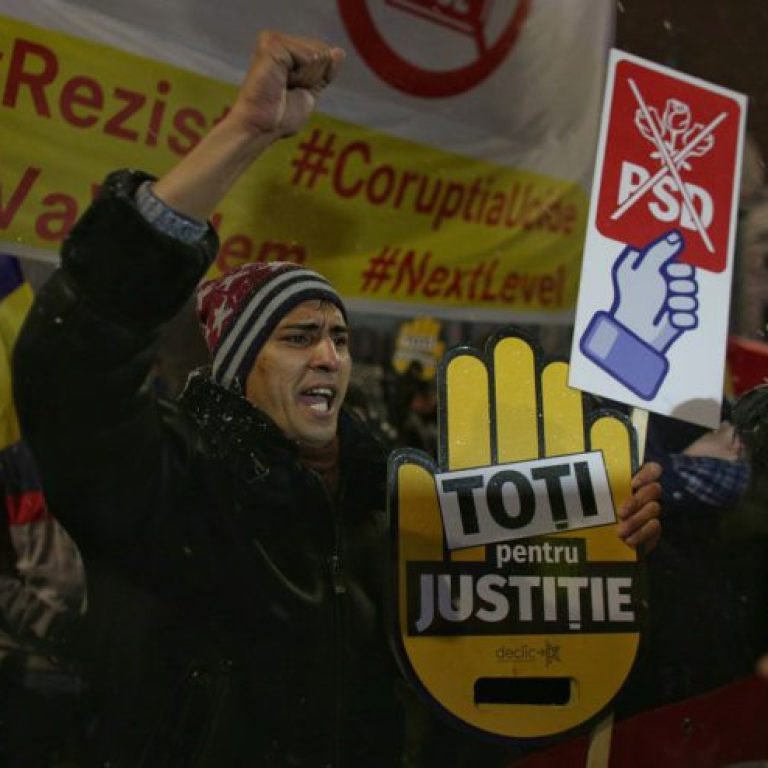 Man takes part in a demonstration in Bucharest