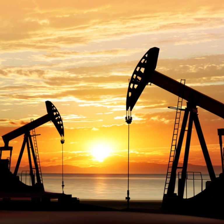 silhouette of working oil pumps on sunset background