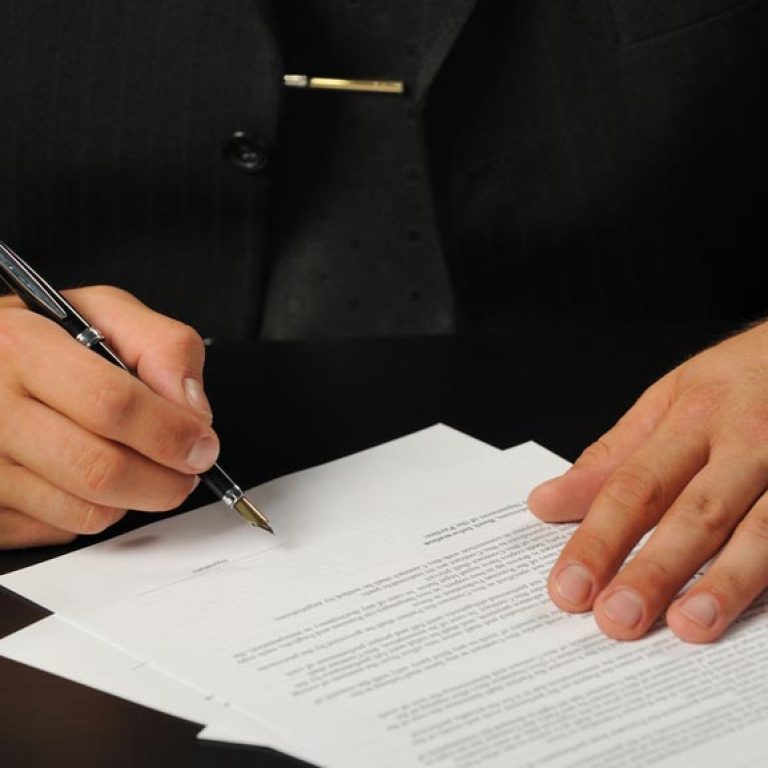 The businessman the signing contract. Hand closeup.